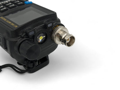Handheld Amateur / GMRS radio with an SMA Male connector which connects to an SMA Female Adapter